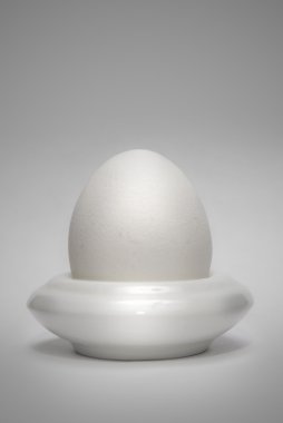 Egg in the eggcup vertical clipart