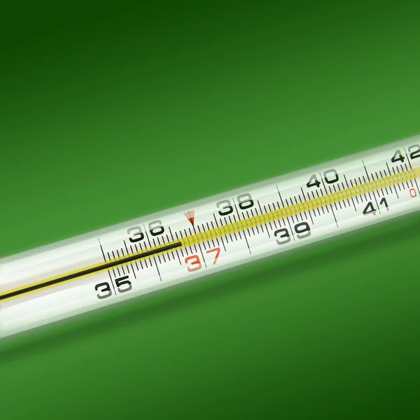 Close-up thermometer on green background — Stock Photo, Image