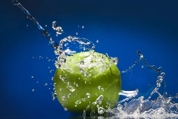 Grüner Apfel mit Wasserspritzer — Stockfoto