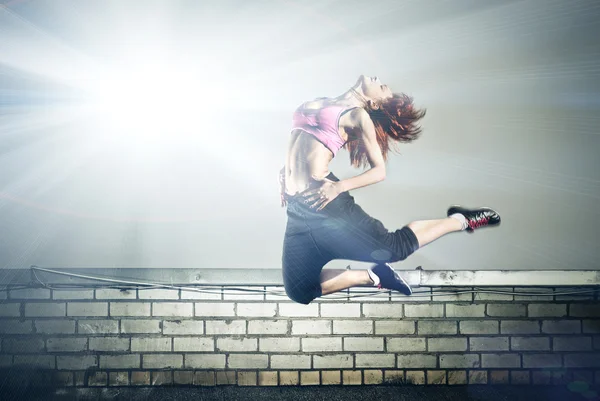 Girl jumping on the roof — Stock Photo, Image