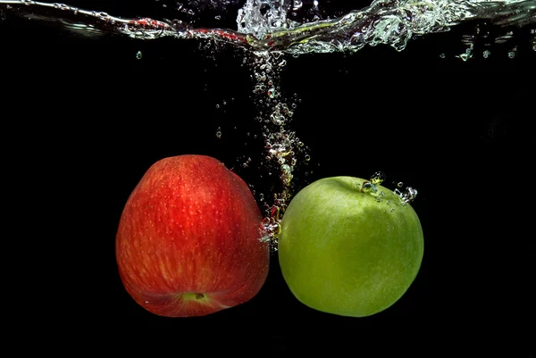 Ref e maçã verde caíram na água — Fotografia de Stock