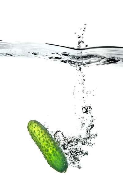 Green cucumber dropped into water — Stock Photo, Image
