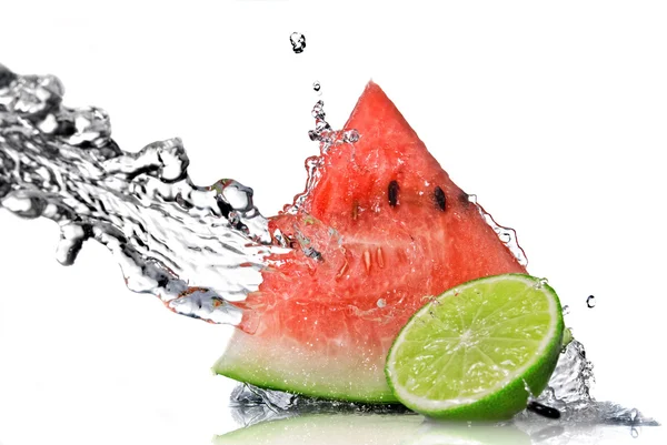 Watermeloen, kalk en water splash Stockfoto