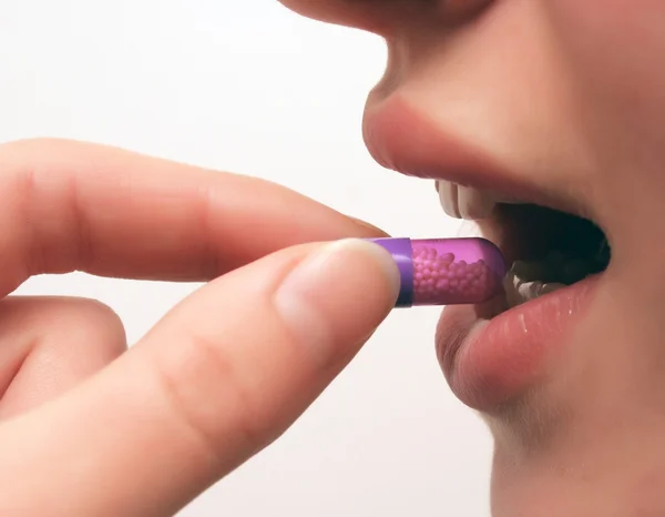 stock image Young woman with pill.