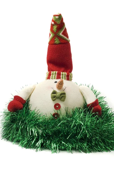 Christmas snowman toy in green tinsel — Stock Photo, Image