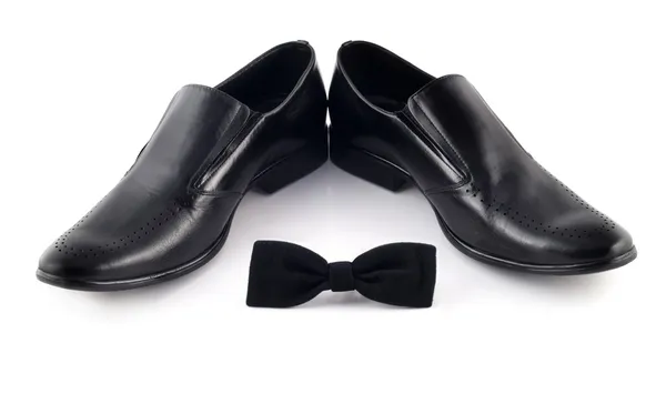 Black bow and mens classic shoes — Stock Photo, Image
