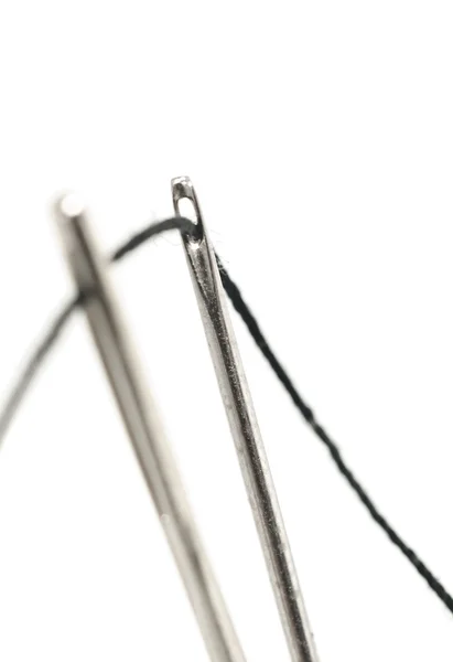 Two needles with thread over white — Stock Photo, Image