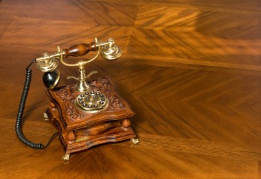 Old-fashioned telephone on table clipart