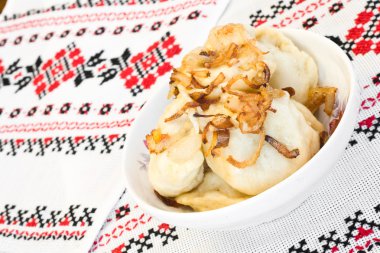 Ukrainian dishes - dumplings with fried onion clipart