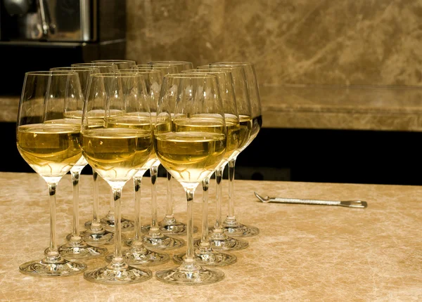 Glazen met witte wijn en opener op marmer — Stockfoto