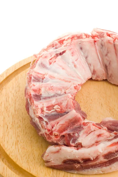 Raw Pork ribs with meat on round hardboard — Stock Photo, Image