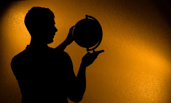 Silhouette of man holding globe — Stock Photo, Image