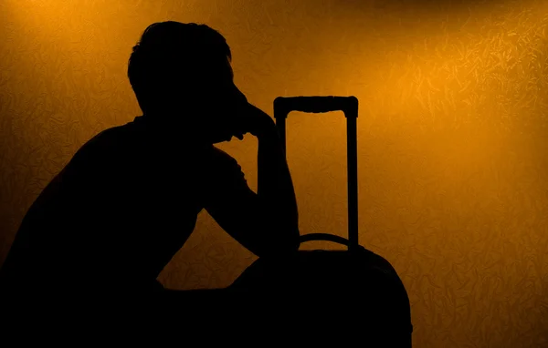 stock image Traveling - silhouette of man and suitcase