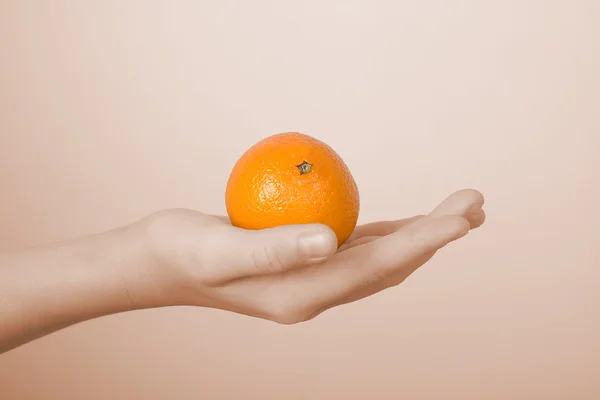 Tangerine on a children — Stock Photo, Image