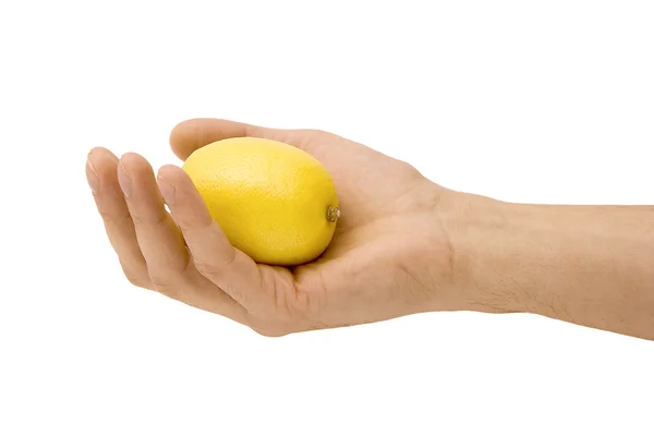 Gele citroen in een hand — Stockfoto