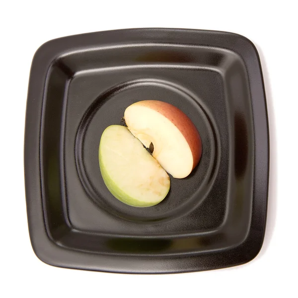 Stock image Two halves of an apple on a plate