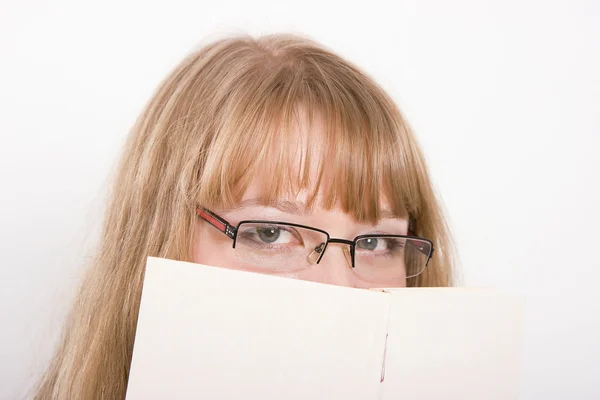The girl hides behind the book — Stock Photo, Image