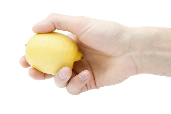 Gele citroen in een hand — Stockfoto