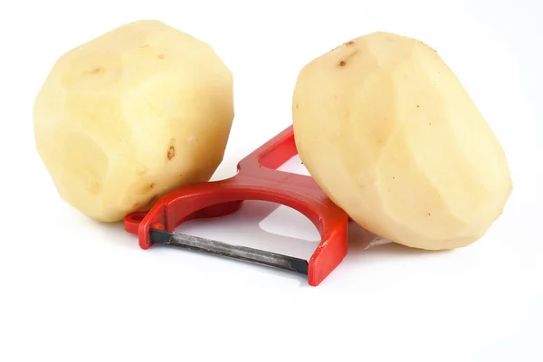 Éplucheur de pommes de terre avec deux pommes de terre — Photo