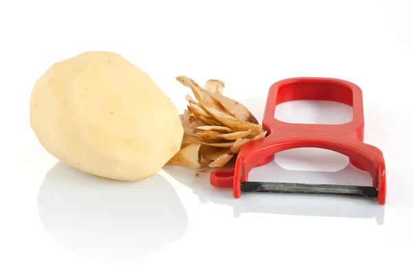 Potato peeler with potato — Stock Photo, Image
