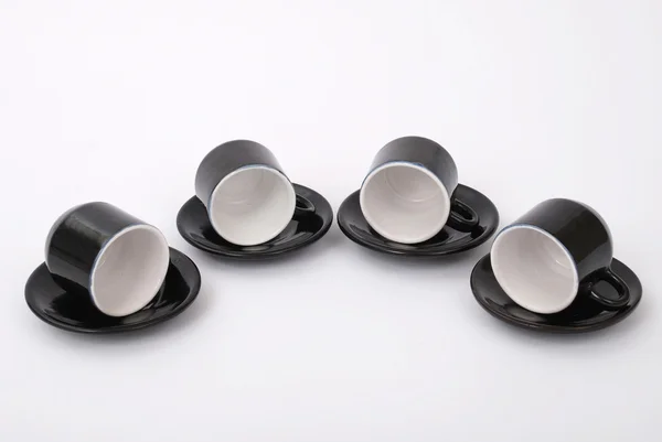 Четыре черные чашки — стоковое фото