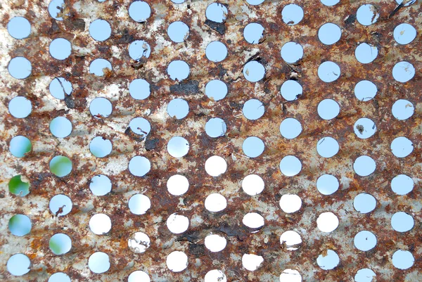 Brown metal plate with holes — Stock Photo, Image