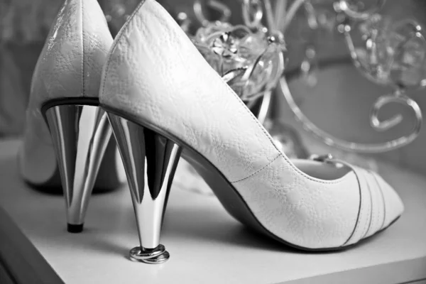 Wedding rings under the heel shoes Royalty Free Stock Photos