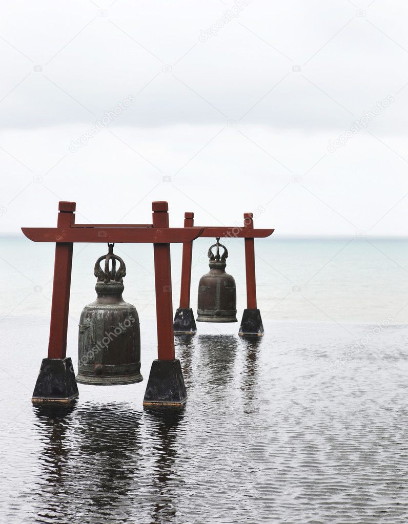 Two old large bells in water