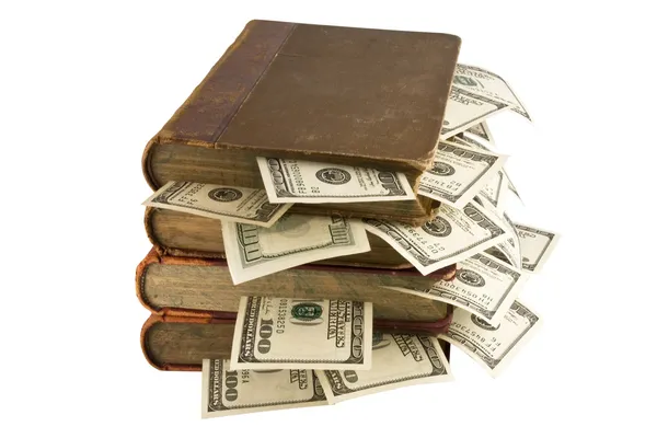 Доллары в старых книгах — стоковое фото