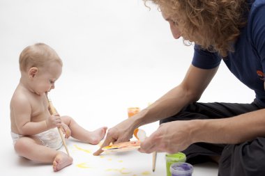 Child is drawing with father clipart