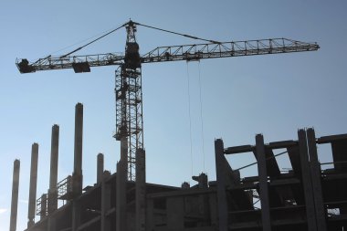 Silhouettes of elevating cranes clipart