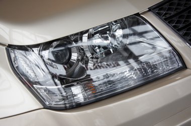 Headlight on a beige car clipart