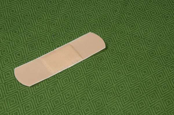 Band aid on Green — Stock Photo, Image