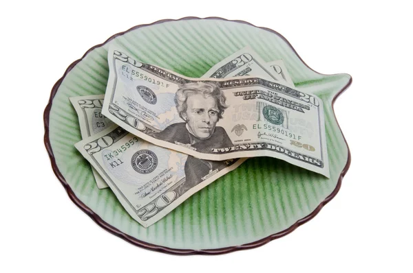 Деньги на тарелке — стоковое фото
