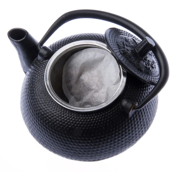 Открытый чайник с чайным пакетиком — стоковое фото