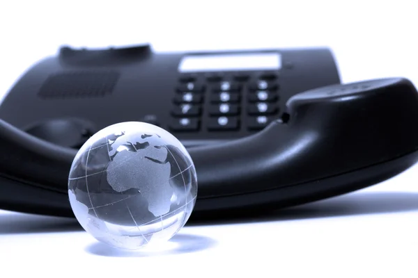 Business phone and glass globe — Stock Photo, Image