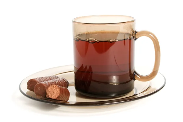 Taza de té y dulces de chocolate —  Fotos de Stock