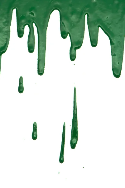 Green paint pouring on white background — Stock Photo, Image