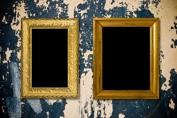 Grunge interior with vintage gold frames — Stock Photo, Image