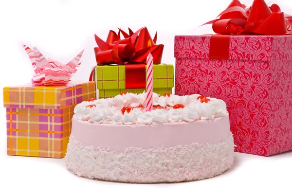 Pink pie with one candle and gifts — Stock Photo, Image
