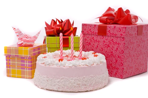 Pink pie with three candle and gifts — Stock Photo, Image