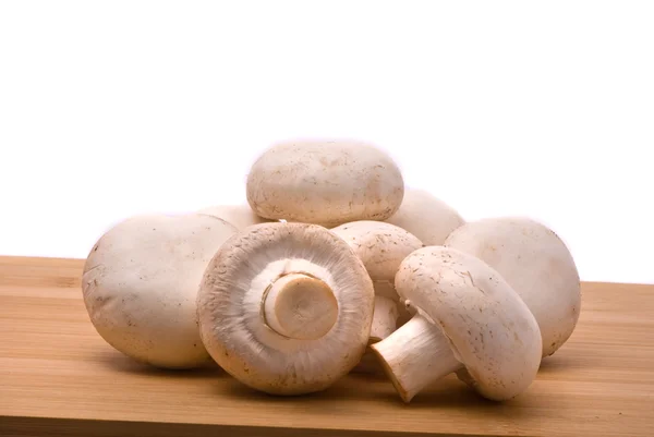 Fresh mushrooms on a chopping board — Stock Photo, Image