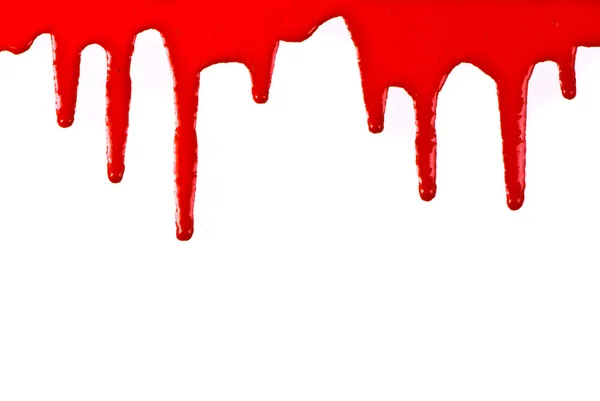 Pintura roja vertiendo sobre fondo blanco — Foto de Stock