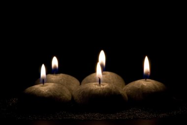 Five candles in the form of stones clipart