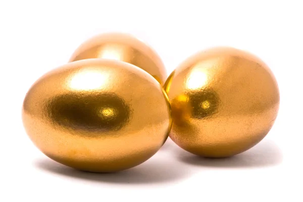 Три золотых яйца — стоковое фото
