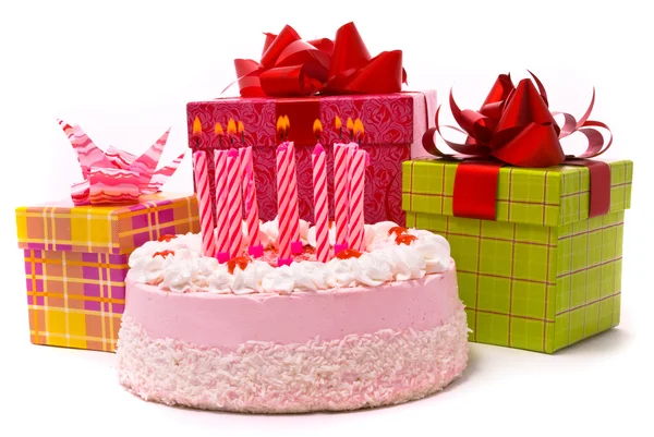 Pink pie with ten candles and gifts — Stock Photo, Image