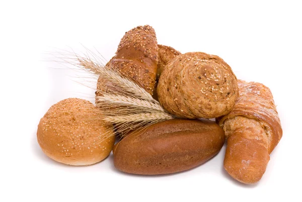 Fresh buns and ears of wheat — Stock Photo, Image
