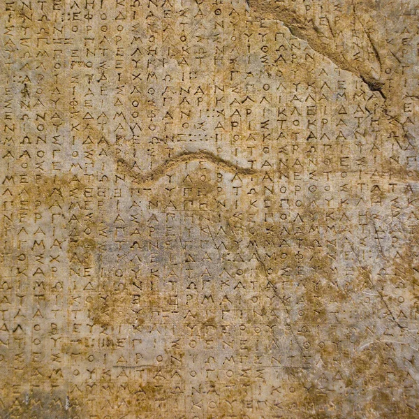 Stenen achtergrond Griekse inscripties — Stockfoto