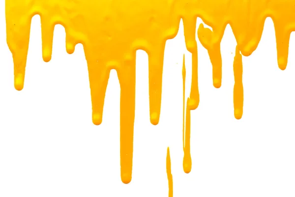 Tinta amarela derramando no fundo branco — Fotografia de Stock