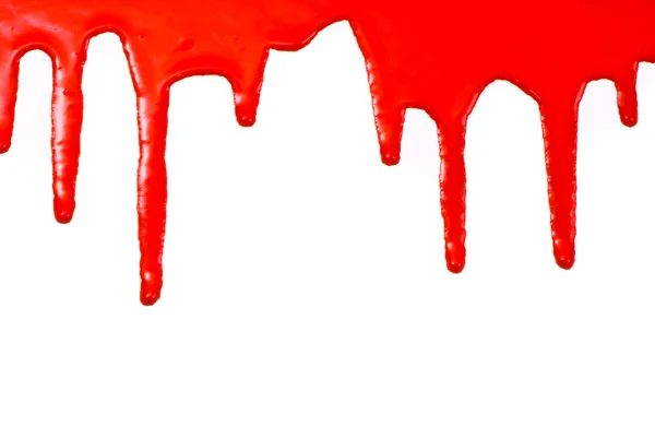 Vernice rossa versando su sfondo bianco — Foto Stock